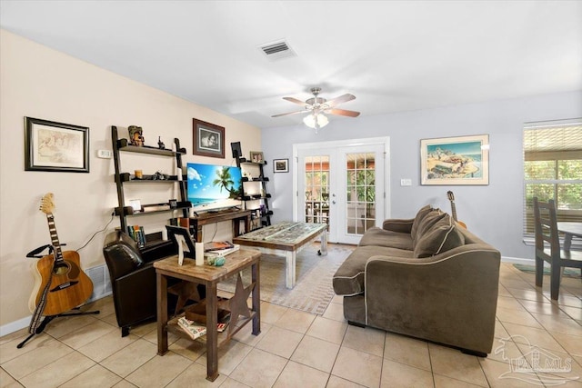 tiled living room with french doors and ceiling fan