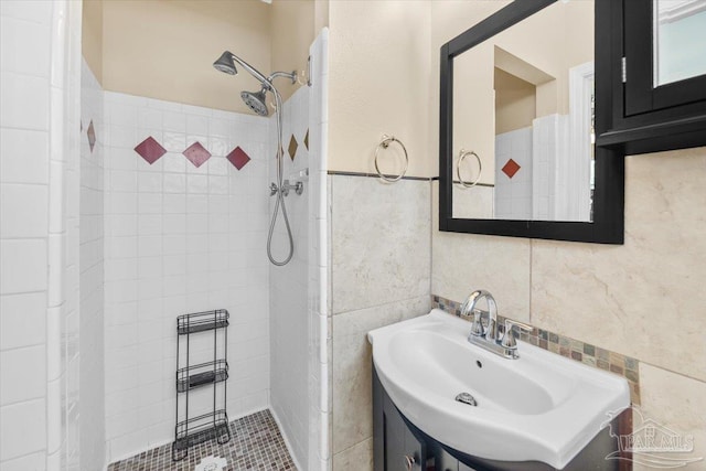 bathroom with sink, a tile shower, and tile walls