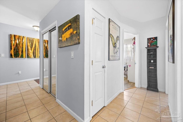 hall featuring light tile patterned floors