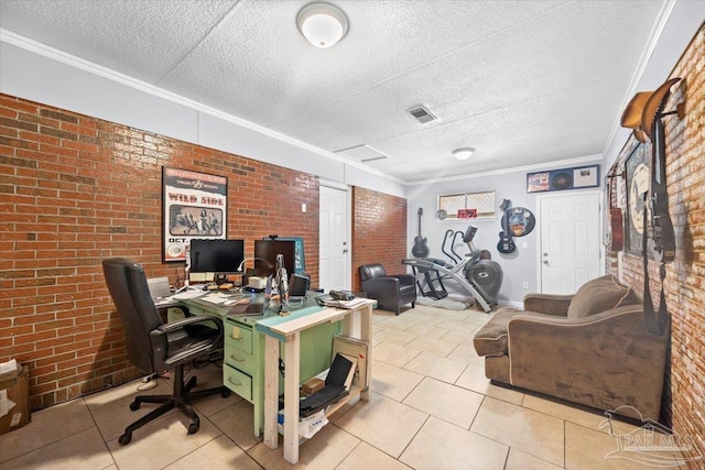 office area with a textured ceiling, light tile patterned floors, ornamental molding, and brick wall