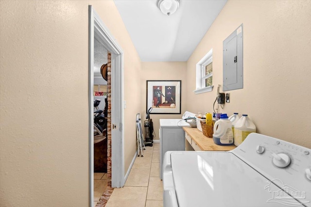 washroom with electric panel, light tile patterned floors, and washing machine and clothes dryer