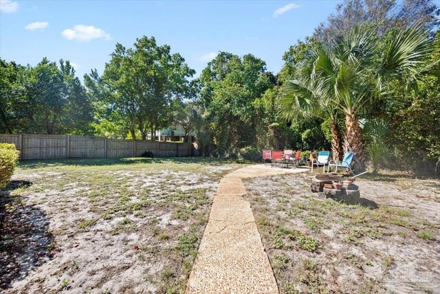 view of yard featuring an outdoor fire pit