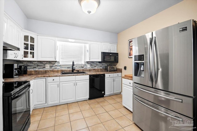 kitchen with black appliances, tasteful backsplash, light tile patterned floors, sink, and white cabinets