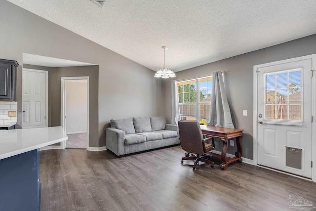 1096 Adrian Way, Milton, FL 32583 - living room with dark wood-type flooring, a textured ceiling, a chandelier, baseboards, and vaulted ceiling