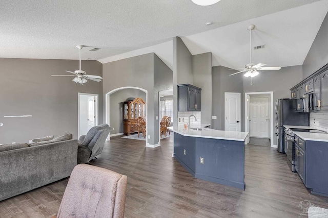 1096 Adrian Way, Milton, FL 32583 - kitchen with a ceiling fan, open floor plan, arched walkways, a sink, and a peninsula
