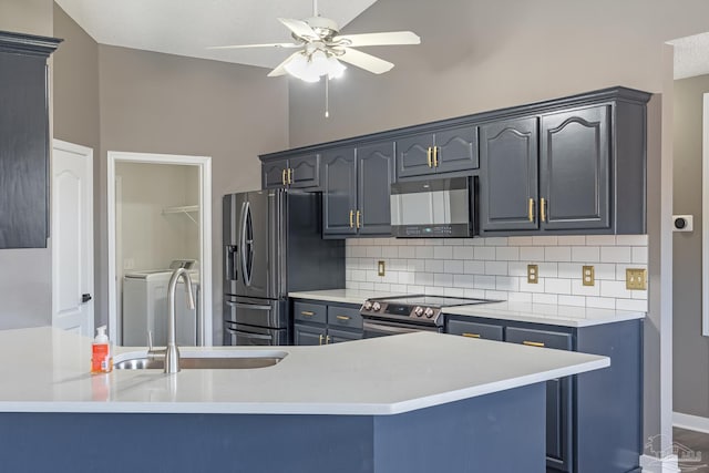 1096 Adrian Way, Milton, FL 32583 - kitchen with appliances with stainless steel finishes, separate washer and dryer, ceiling fan, backsplash, and a sink