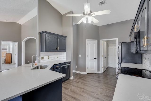 1096 Adrian Way, Milton, FL 32583 - kitchen featuring dishwashing machine, a sink, high vaulted ceiling, a ceiling fan, and light countertops