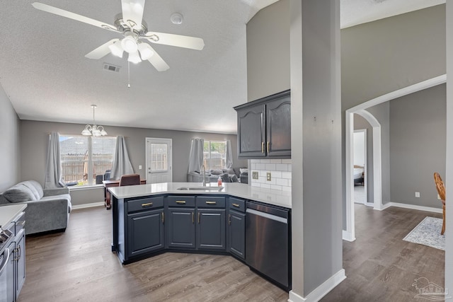 1096 Adrian Way, Milton, FL 32583 - kitchen with dishwasher, a sink, a peninsula, light countertops, and light wood-style flooring