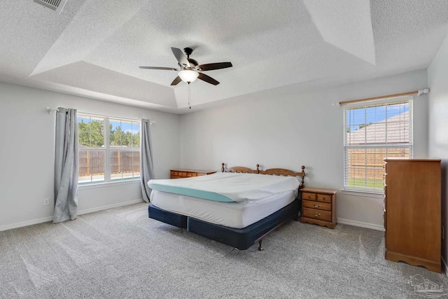 1096 Adrian Way, Milton, FL 32583 - carpeted bedroom with a textured ceiling, a raised ceiling, baseboards, and a ceiling fan