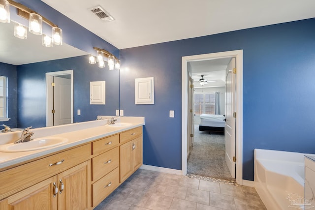 1096 Adrian Way, Milton, FL 32583 - bathroom with ensuite bathroom, baseboards, tile patterned floors, double vanity, and a bath