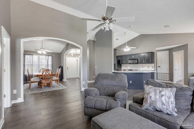 1096 Adrian Way, Milton, FL 32583 - living area featuring ceiling fan, arched walkways, dark wood finished floors, high vaulted ceiling, and baseboards