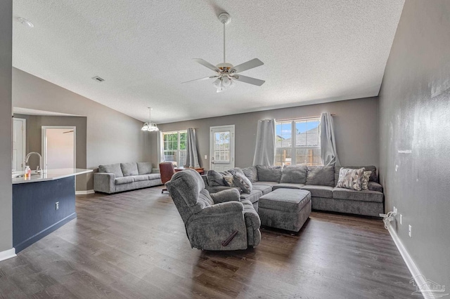 1096 Adrian Way, Milton, FL 32583 - living room featuring a textured ceiling, vaulted ceiling, dark wood-style floors, ceiling fan, and baseboards