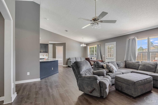 1096 Adrian Way, Milton, FL 32583 - living room with a textured ceiling, vaulted ceiling, plenty of natural light, ceiling fan, and wood finished floors