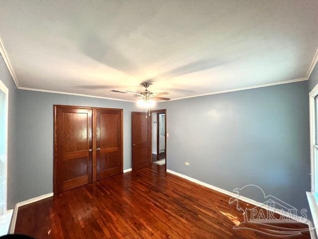 unfurnished bedroom featuring ornamental molding, ceiling fan, and dark hardwood / wood-style flooring