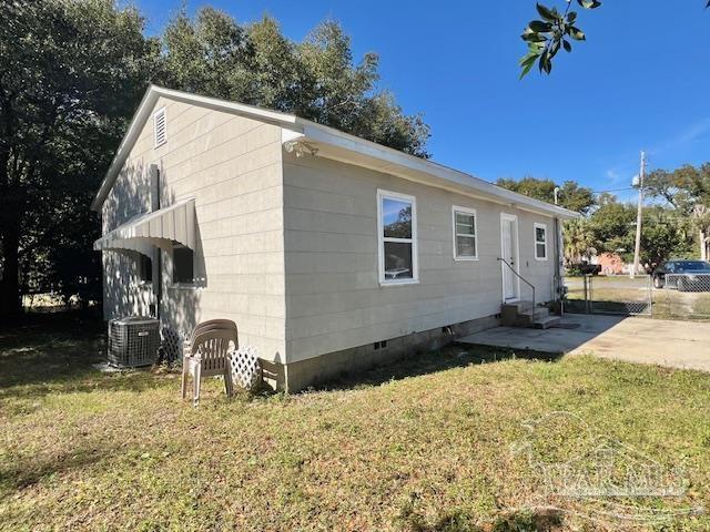 view of property exterior with a yard and central AC unit