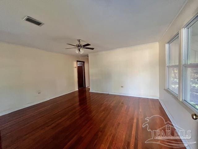 empty room featuring ceiling fan and dark wood-type flooring