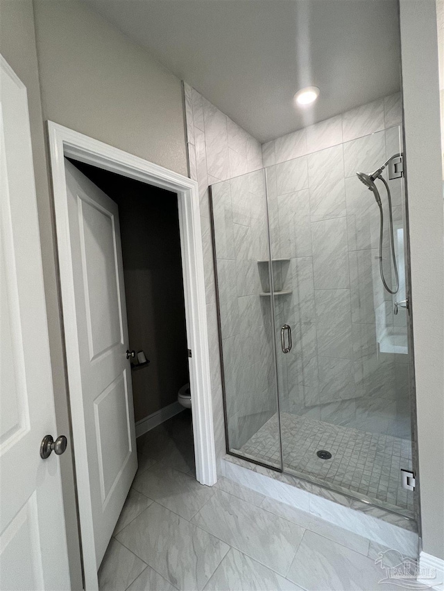 2305 Habersham Ln, Cantonment, FL 32533 - bathroom featuring toilet, a shower stall, marble finish floors, and baseboards