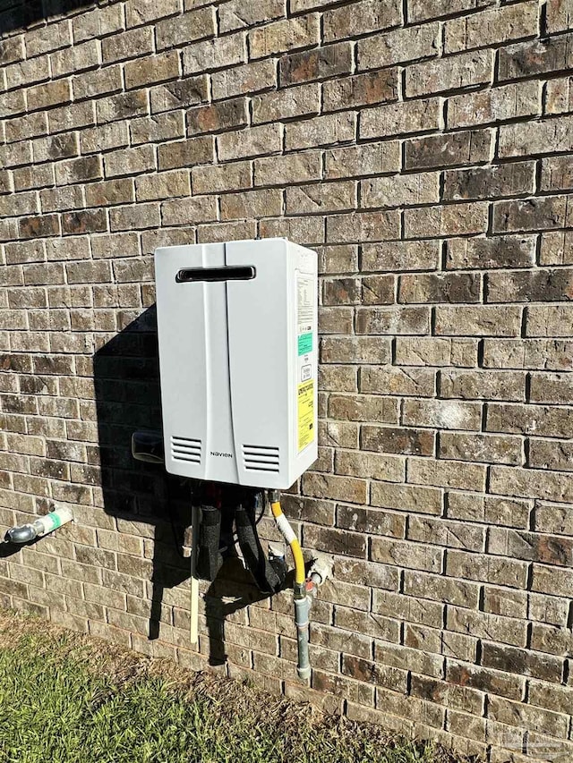 2305 Habersham Ln, Cantonment, FL 32533 - exterior view of brick siding and tankless water heater