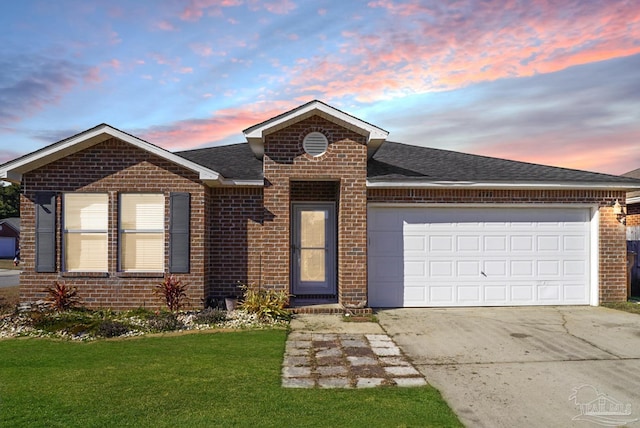 view of front of home featuring a yard and a garage