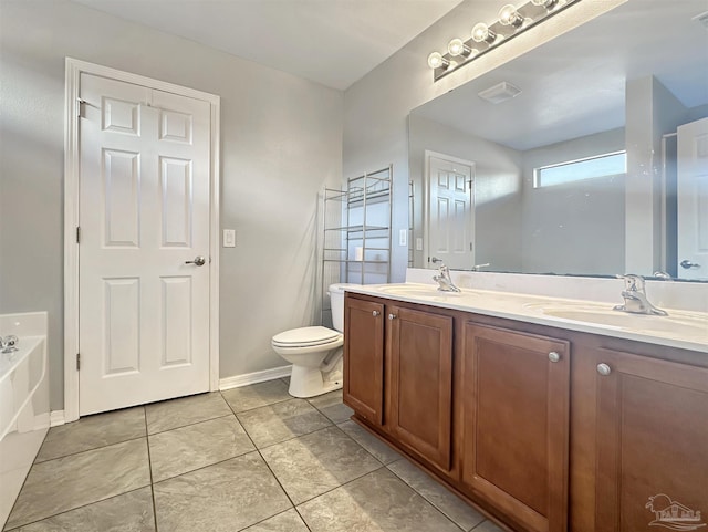 bathroom featuring tile patterned flooring, vanity, a washtub, and toilet