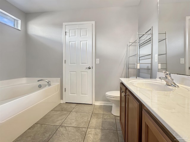 bathroom with vanity, a bath, tile patterned floors, and toilet