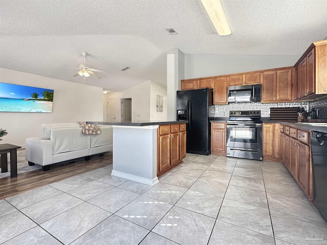 kitchen with lofted ceiling, ceiling fan, backsplash, black appliances, and a textured ceiling