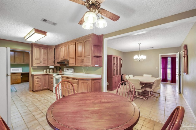 kitchen featuring ceiling fan with notable chandelier, white appliances, a textured ceiling, hanging light fixtures, and light tile patterned floors