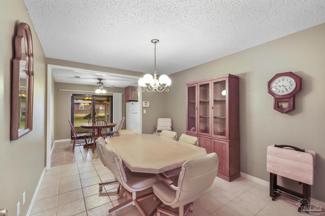 dining area featuring ceiling fan with notable chandelier, a textured ceiling, and light tile patterned flooring