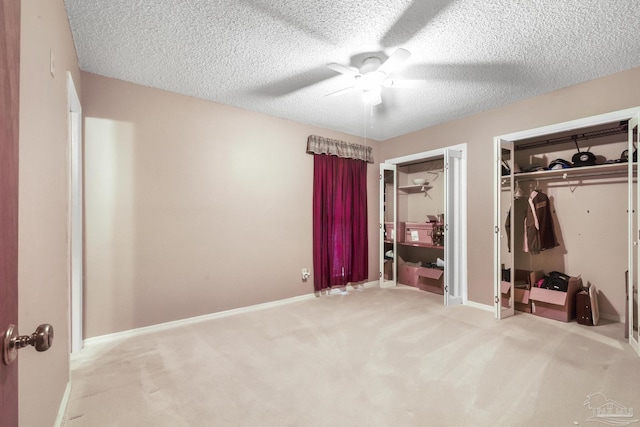 carpeted bedroom featuring ceiling fan and a textured ceiling