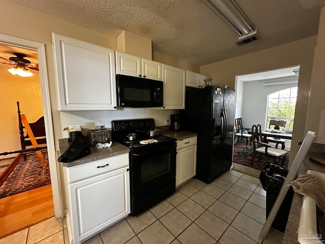 kitchen with a textured ceiling, white cabinetry, black appliances, light tile patterned floors, and ceiling fan