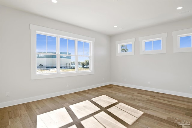 empty room with light hardwood / wood-style floors