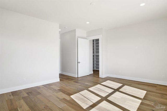 unfurnished room with hardwood / wood-style floors