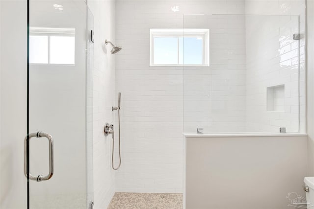 bathroom with a shower with door