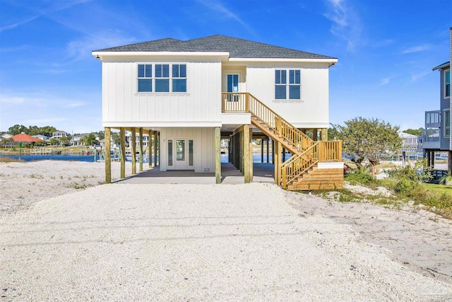 view of front of property with a carport and a water view