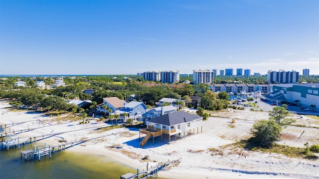 bird's eye view with a water view and a beach view