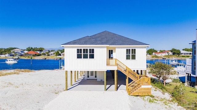 view of front of home featuring a water view and a carport