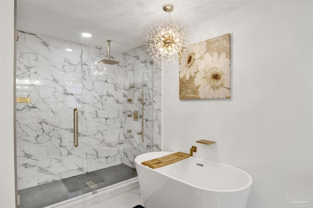 full bath featuring marble finish floor, a marble finish shower, a textured ceiling, and a soaking tub