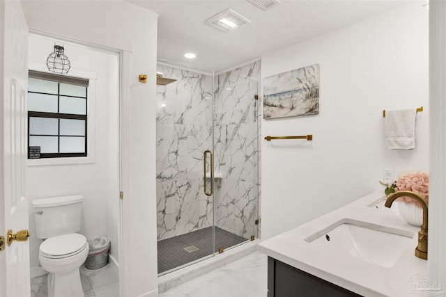 bathroom featuring marble finish floor, a sink, a marble finish shower, and toilet