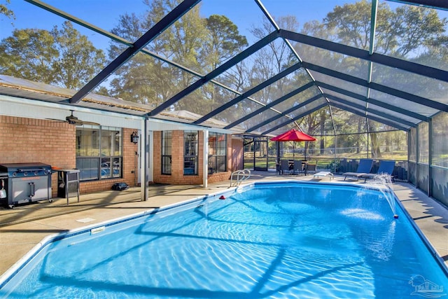 outdoor pool with glass enclosure, a grill, and a patio