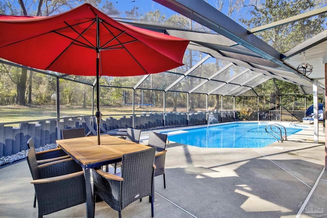 view of pool with a lanai, a fenced in pool, and a patio