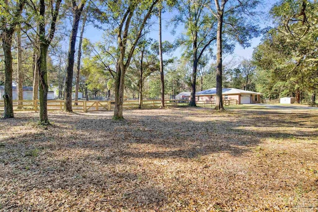 view of yard featuring fence and an attached garage