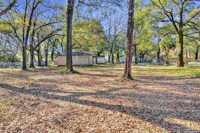 view of yard with a garage and fence