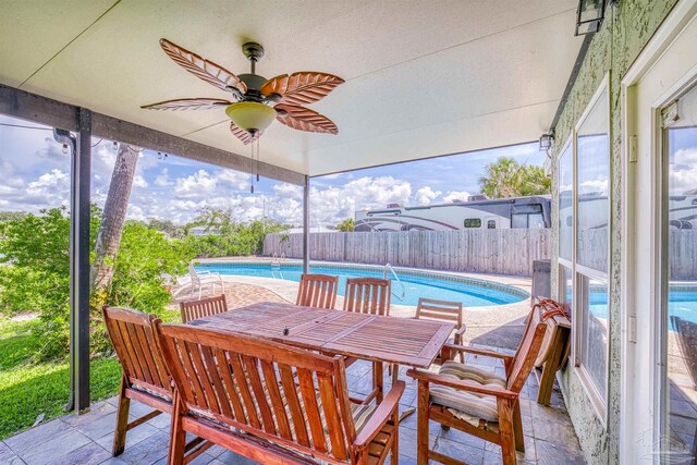 exterior space with a fenced in pool and ceiling fan