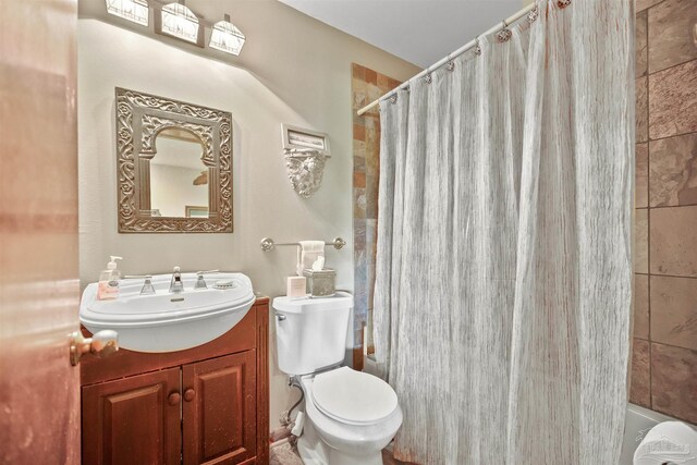 bathroom with vanity, a shower with shower curtain, and toilet