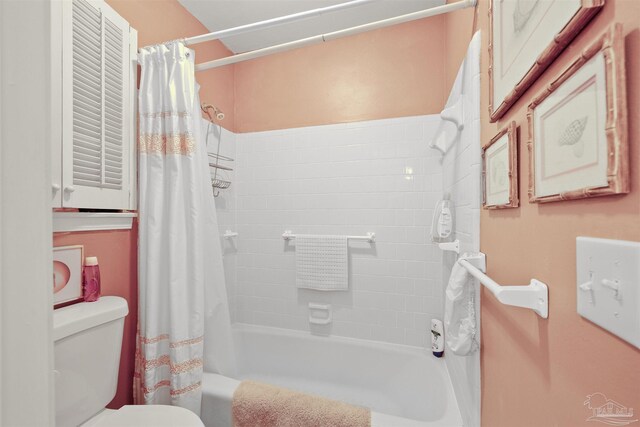 bathroom with shower / bathtub combination with curtain and toilet