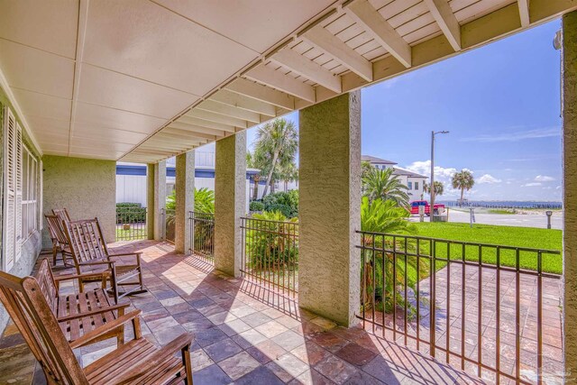 view of patio with a water view