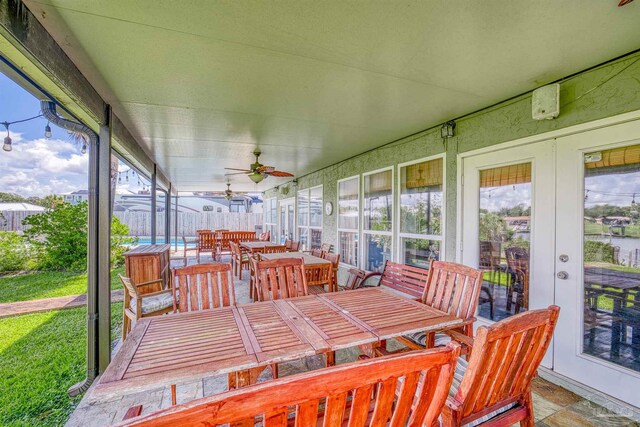 sunroom / solarium featuring ceiling fan and a healthy amount of sunlight