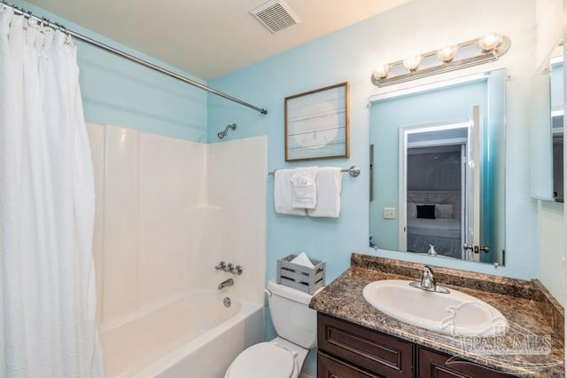 full bathroom featuring vanity, shower / tub combo with curtain, and toilet