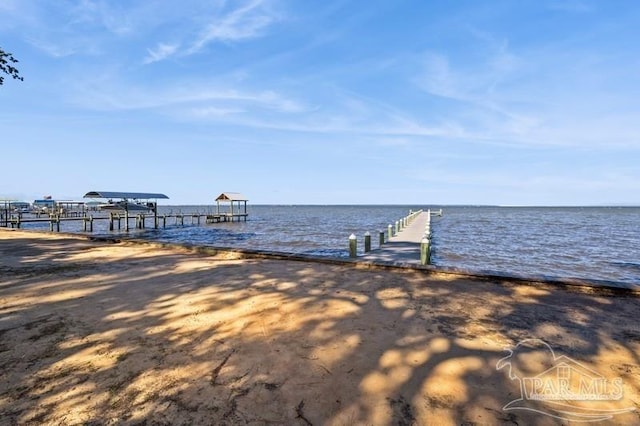 dock area featuring a view of the beach and a water view