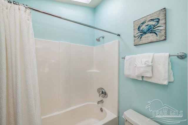 bathroom with toilet, shower / bathtub combination with curtain, and a skylight